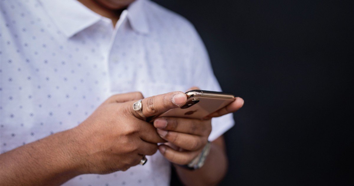 Man checking his smartphone instead of focusing on work