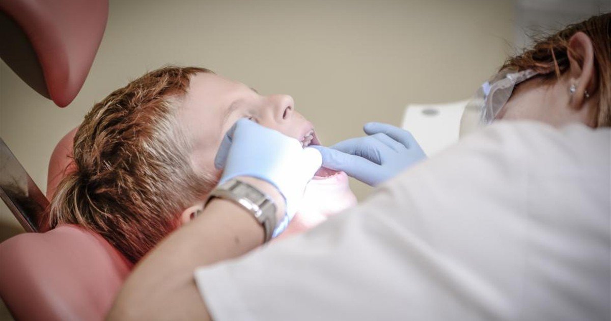 Dentist examining a patient's teeth during a routine checkup